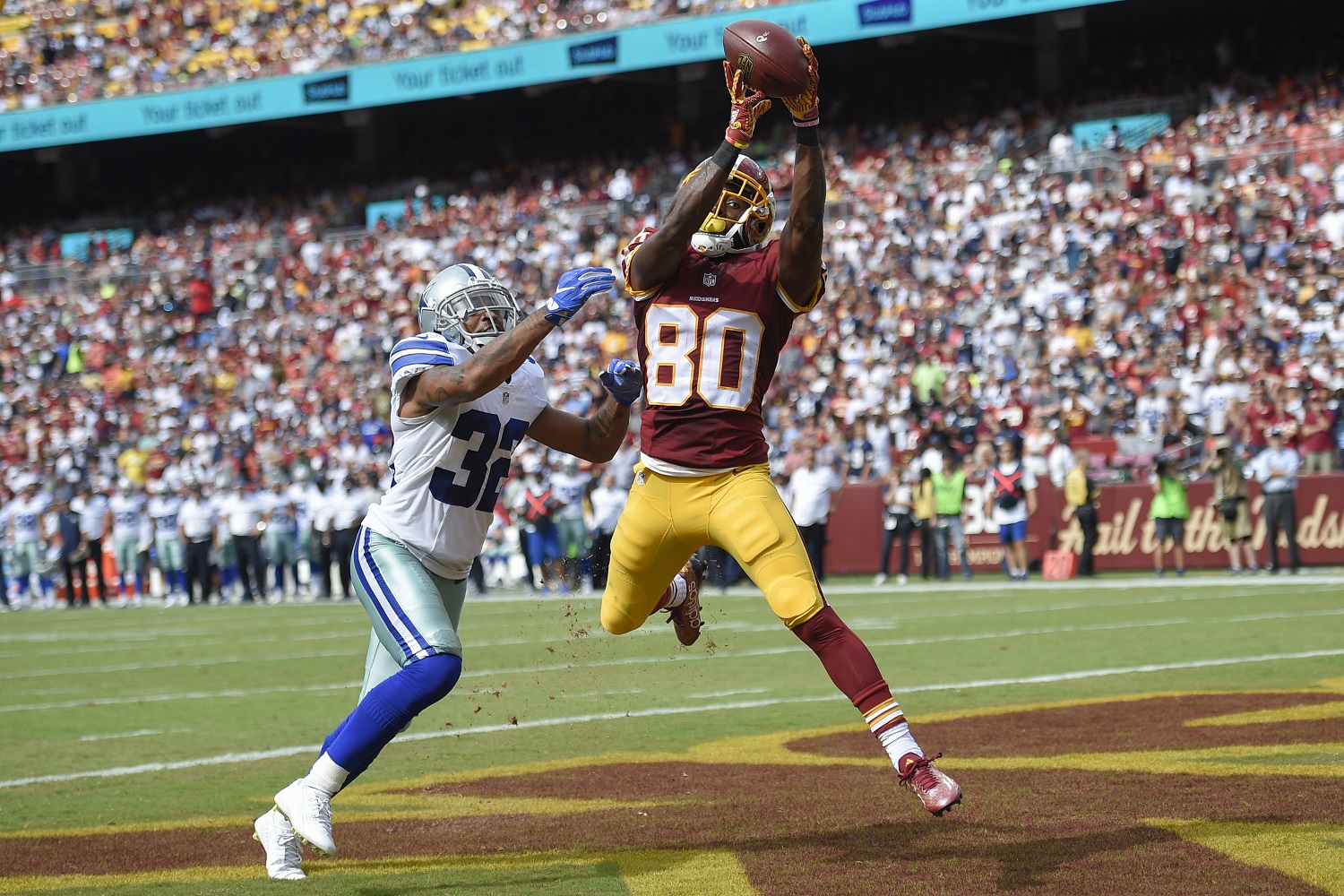 Washington Redskins wide receiver Jamison Crowder (80) pulls in a touchdown pass under pressure from Dallas Cowboys cornerback Orlando Scandrick (32) during the second half of an NFL football game in Landover, Md., Sunday, Sept. 18, 2016. (AP Photo/Nick Wass)