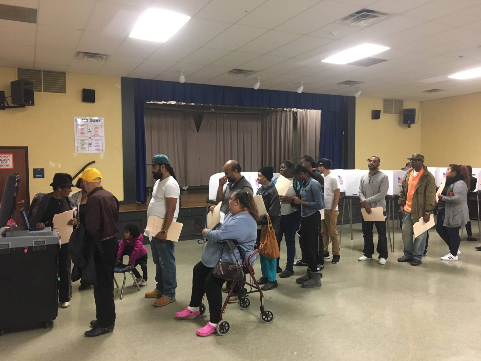 Voters wait to use the one scanner in use at Adelphi Elementary School in Prince George's County as of 1:50 p.m. Tuesday, Nov. 8. Some have waited more than 45 minutes. (WTOP/Mike Murillo)