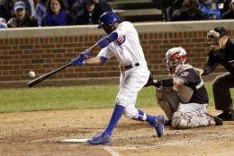 Chicago Cubs' Dexter Fowler hits a home run against the Cleveland Indians during the eighth inning of Game 4 of the Major League Baseball World Series Saturday, Oct. 29, 2016, in Chicago. (AP Photo/Charles Rex Arbogast)