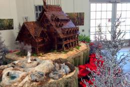 It seems the entire garden is decked out for the holiday season, including this recreation of Old Faithful Inn and Geyser. (WTOP/Megan Cloherty)