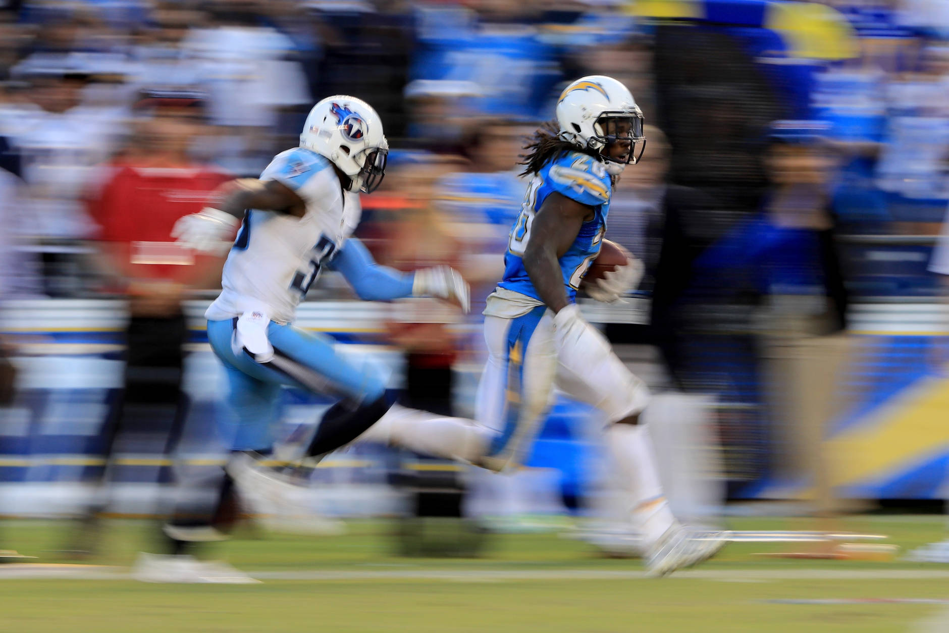 SAN DIEGO, CA - NOVEMBER 06:   Melvin Gordon #28 of the San Diego Chargers eludes  Jason McCourty #30 of the Tennessee Titans on a 35 yard pass play during the second half of a game at Qualcomm Stadium on November 6, 2016 in San Diego, California.  (Photo by Sean M. Haffey/Getty Images)