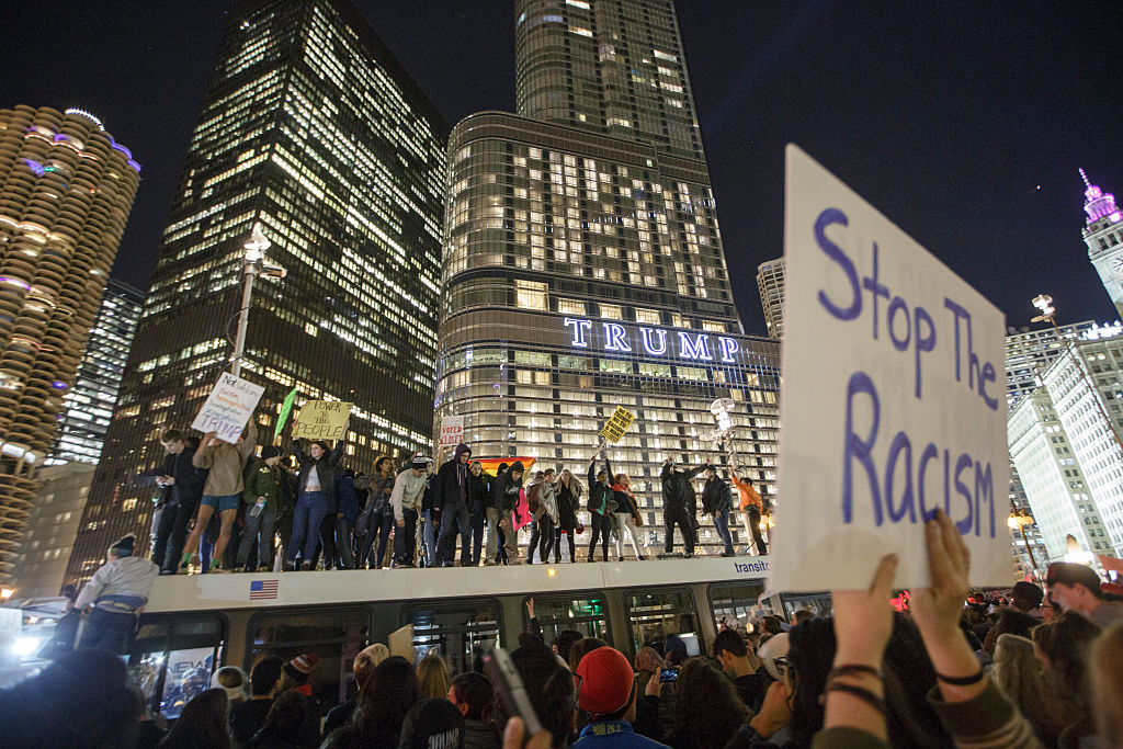 CHICAGO, IL - NOVEMBER 09: Demonstrators protest on top of a bus outside of the Trump Tower November 9, 2016 in Chicago, Illinois. Thousands of people across the United States took to the streets in protest a day after Republican Donald Trump was elected president, defeating Democrat Hillary Clinton. (Photo by John Gress/Getty Images)