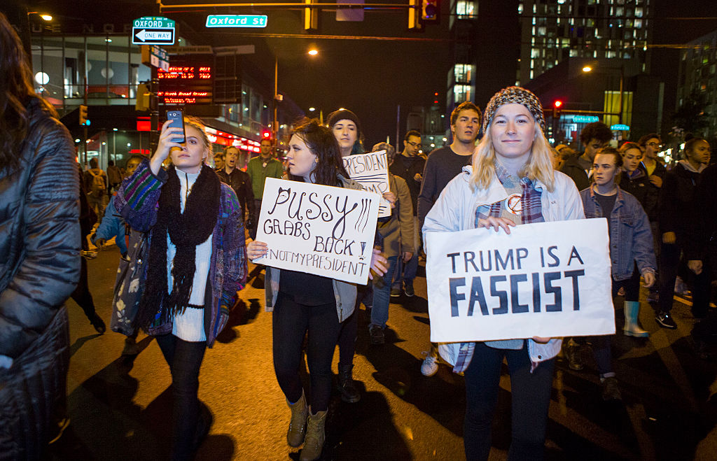 PHILADELPHIA, PA - NOVEMBER 09:  (EDITORS NOTE: Image contains profanity) People march in the streets in protest of the election of Republican Donald Trump on November 9, 2016 in North Philadelphia, Pennsylvania. Trump's victory was widely seen as an upset.  (Photo by Jessica Kourkounis/Getty Images)