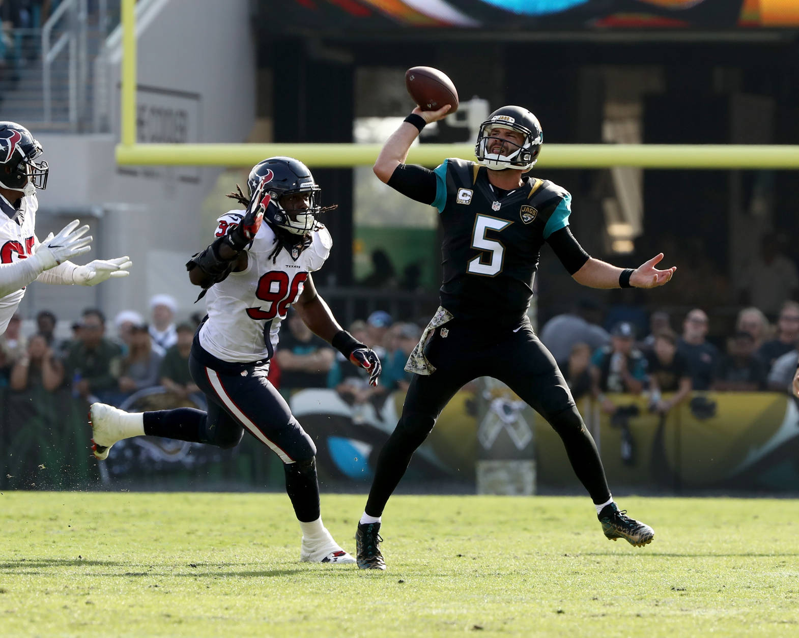 JACKSONVILLE, FL - NOVEMBER 13:   Blake Bortles #5 of the Jacksonville Jaguars attempts a pass as he's pursued by Jadeveon Clowney #90 of the Houston Texans during the game at EverBank Field on November 13, 2016 in Jacksonville, Florida.  (Photo by Sam Greenwood/Getty Images)