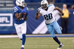 INDIANAPOLIS, IN - NOVEMBER 20:  T.Y. Hilton #13 of the Indianapolis Colts catches a pass while being guarded by Perrish Cox #20 of the Tennessee Titans during the fourth quarter of the game at Lucas Oil Stadium on November 20, 2016 in Indianapolis, Indiana.  (Photo by Stacy Revere/Getty Images)