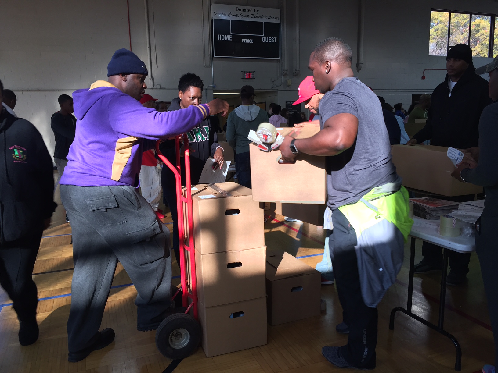 Volunteers for Northern Virginia Project Giveback worked together to box 200 boxes of Thanksgiving food for those in need Saturday, Nov. 16, 2016 in Alexandria, Virginia. (WTOP/Dennis Foley)