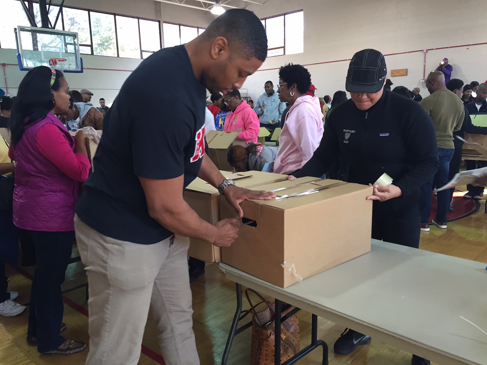 Volunteers came from near and far to help Northern Virginia Project Giveback put together hundreds of boxes of food for those in need Saturday, Nov. 16, 2016 in Alexandria, Virginia. (WTOP/Dennis Foley)
