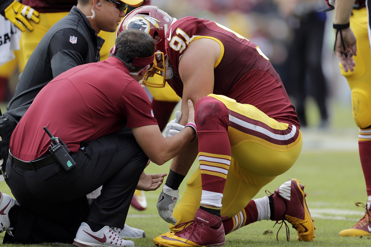 Washington Redskins outside linebacker Ryan Kerrigan (91) is assisted after an injury during the first half of an NFL football game against the Cleveland Browns, Sunday, Oct. 2, 2016, in Landover, Md. (AP Photo/Mark Tenally)