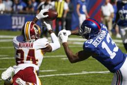 Washington Redskins cornerback Josh Norman (24) fights for control of the ball with New York Giants' Odell Beckham (13) during the first half of an NFL football game Sunday, Sept. 25, 2016, in East Rutherford, N.J. (AP Photo/Kathy Willens)