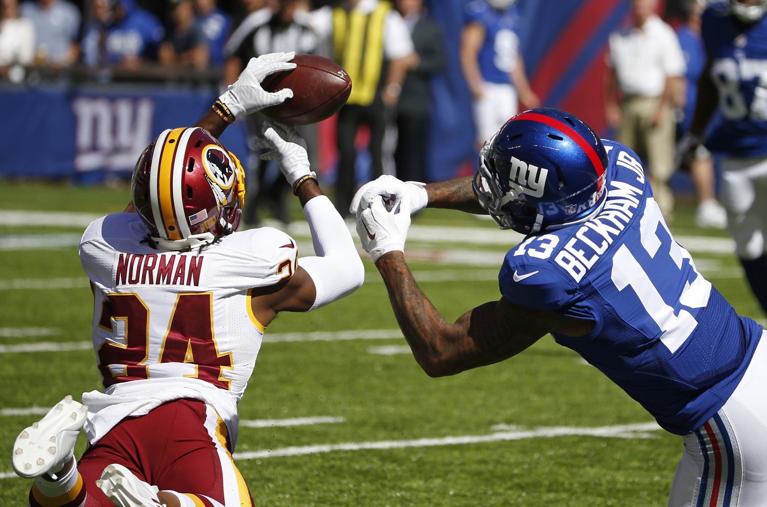 Washington Redskins cornerback Josh Norman (24) fights for control of the ball with New York Giants' Odell Beckham (13) during the first half of an NFL football game Sunday, Sept. 25, 2016, in East Rutherford, N.J. (AP Photo/Kathy Willens)