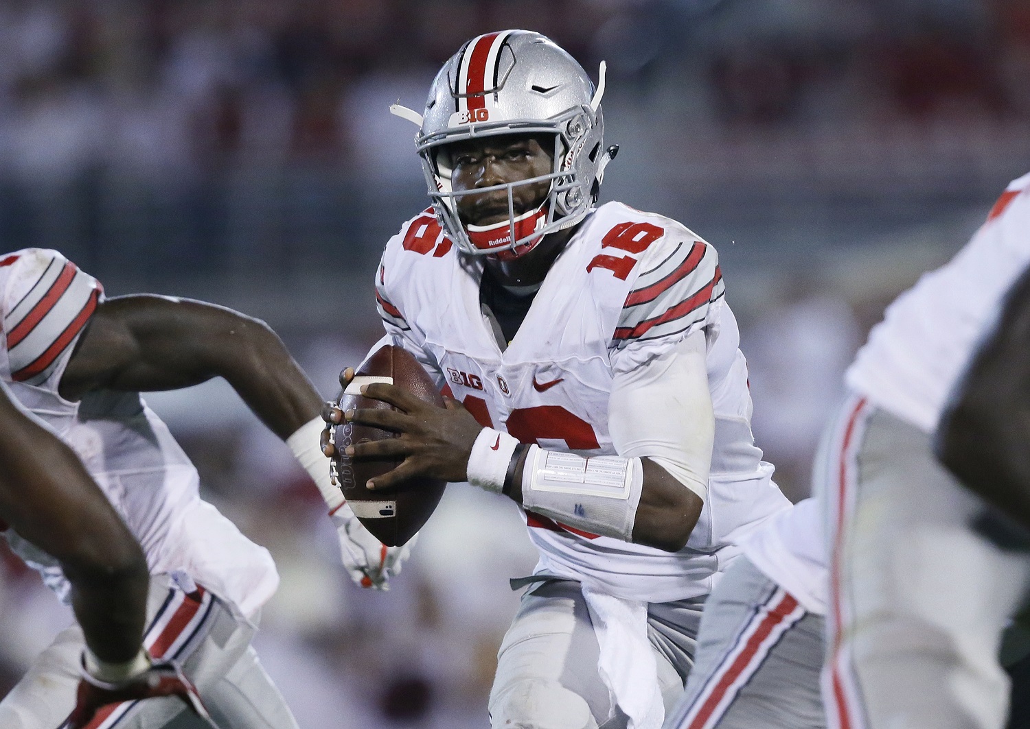 FILE - In this Saturday, Sept. 17, 2016, file photo, Ohio State quarterback J.T. Barrett (16) scrambles during the fourth quarter of an NCAA college football game against Oklahoma in Norman, Okla. After blowing away opponents in the first four games, Ohio State’s plummet back to earth has included offensive woes, an upset by unranked Penn State and a narrow escape against three-touchdown underdog Northwestern at home. Coach Urban Meyer has taken to calling the team a “project” still in the works, as if to reset expectations that soared in the first month of the season when quarterback Barrett was breaking school passing records and new ball-hawking stars were emerging on the defense. (AP Photo/Sue Ogrocki, File)