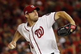 Washington Nationals starting pitcher Max Scherzer winds up during the first inning in Game 5 of baseball's National League Division Series, against the Los Angeles Dodgers at Nationals Park, Thursday, Oct. 13, 2016, in Washington. (AP Photo/Pablo Martinez Monsivais)