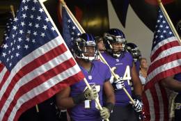 Baltimore Ravens cornerback Anthony Levine (41) and offensive guard John Urschel (64) wait to run onto the field with United States flags before an NFL football game against the Pittsburgh Steelers, Sunday, Nov. 6, 2016, in Baltimore. (AP Photo/Nick Wass)