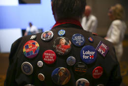 Larry Coffey poses with his pins supporting Democratic presidential candidate Hillary Clinton during an election watch party in Las Vegas, Tuesday, Nov. 8, 2016. (AP Photo/Chase Stevens)