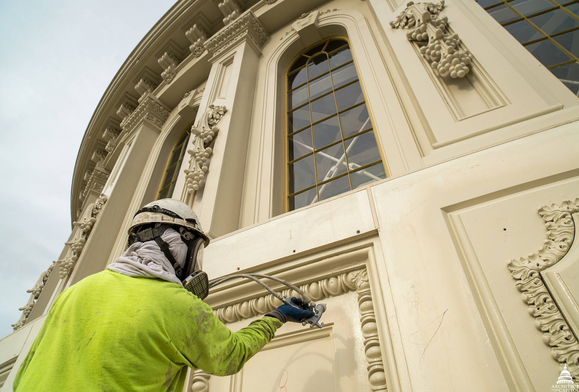 A workman applies paint to the dome of the U.S. Capitol. (Architect of the Capitol)