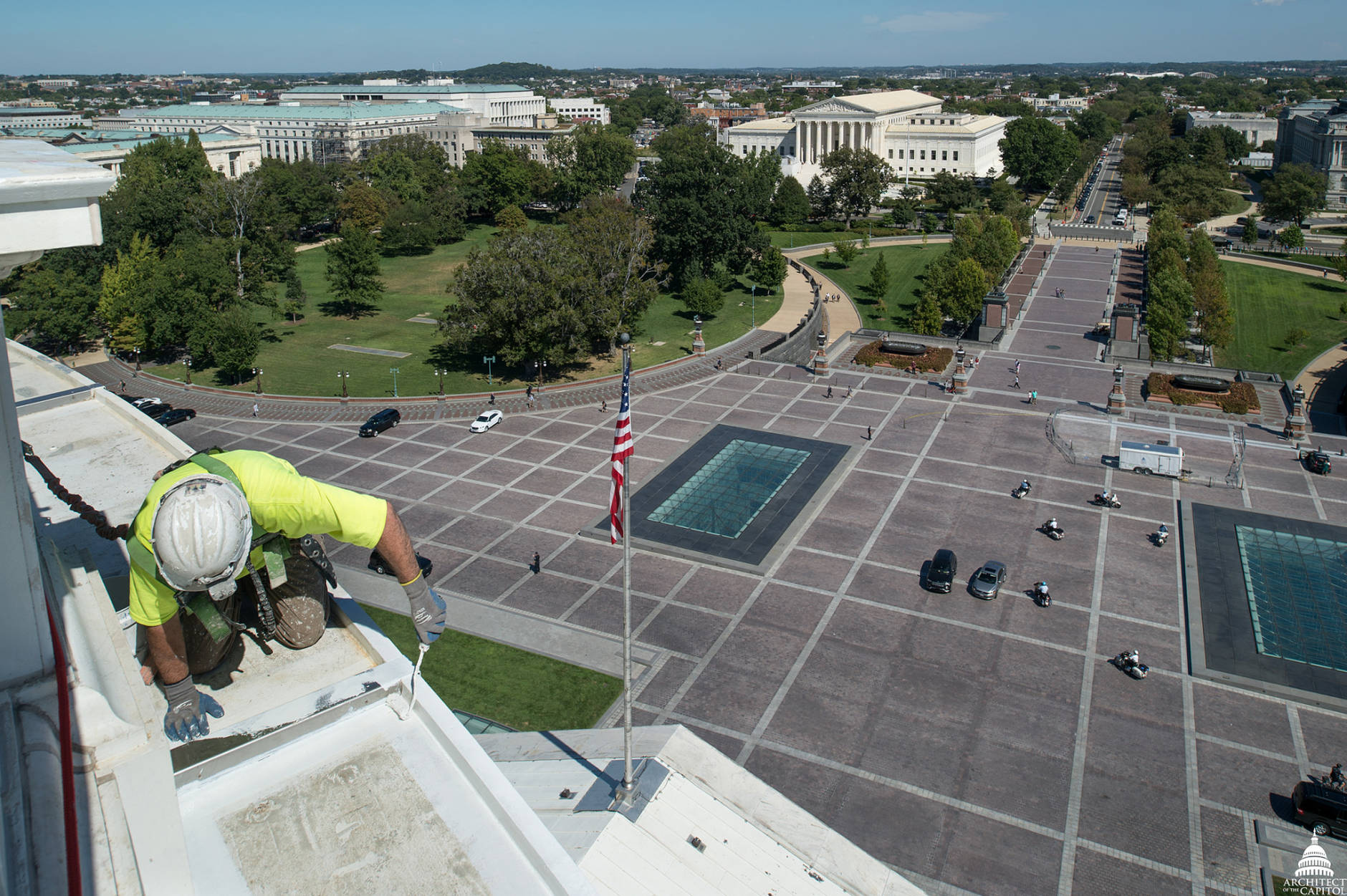View from the top. A workman carefully works above the U.S. Capitol grounds (Architect of the Capitol)