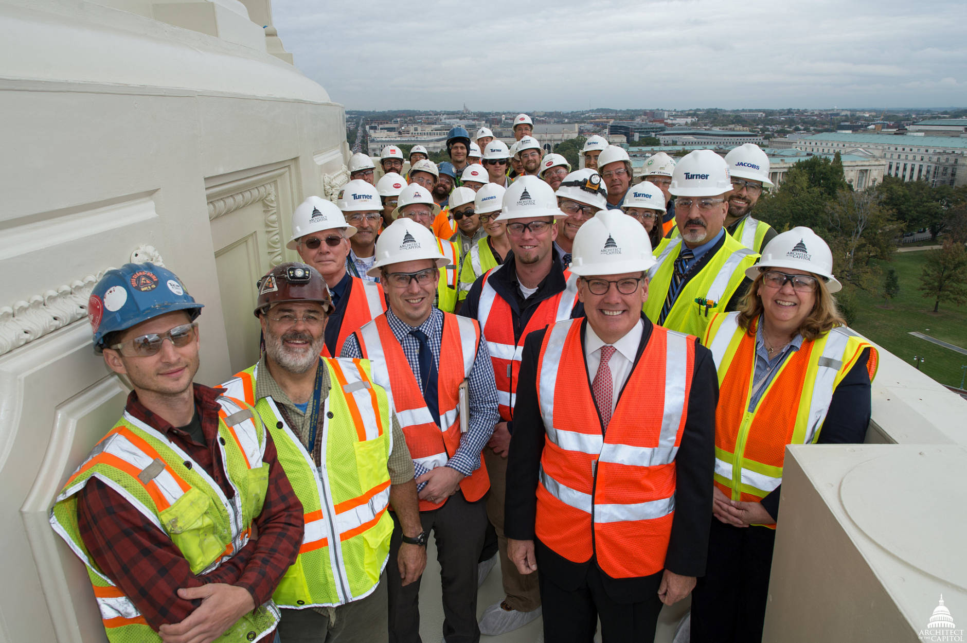 The Honorable Stephen T. Ayers, FAIA, LEED AP, Architect of the Capitol, joined members of the Dome Restoration team to attach the final restored ornament, a rosette, to the U.S. Capitol Dome. (Architect of the Capitol)
