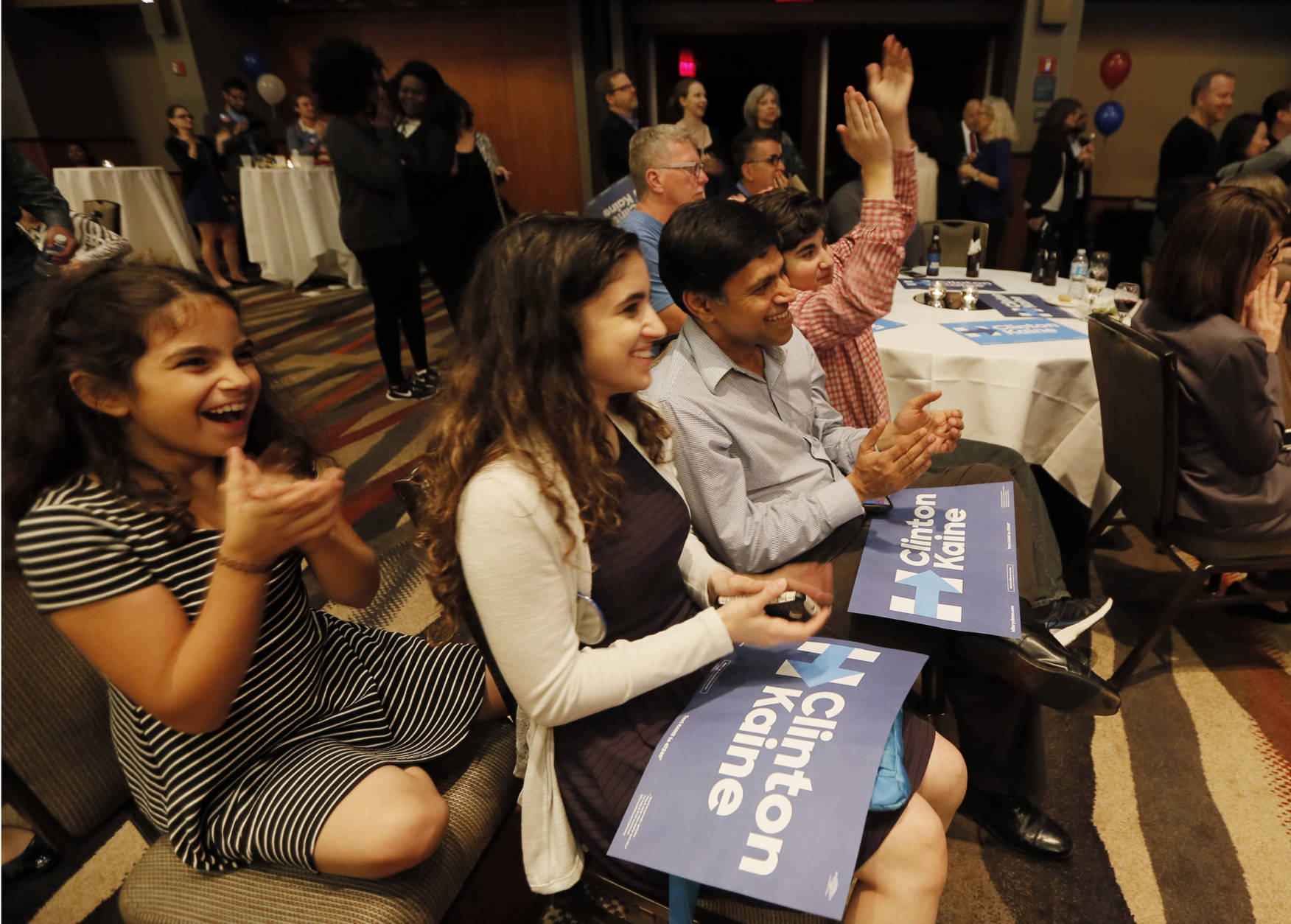 Izzy Agarawal, from left, with her sister Cathy, father, Raj and brother Ben, right, celebrate as they watch returns during the Dallas County Democrats watch party, Tuesday Nov. 8, 2016, in Dallas. (AP Photo/Tony Gutierrez)