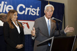 Former Florida Gov. Charlie Crist gestures after being elected to the U.S. House of Representatives Tuesday, Nov. 8, 2016, in St. Pete Beach, Fla. Crist defeated Republican David Jolly. Looking on is Crist's wife Carole. (AP Photo/Chris O'Meara)