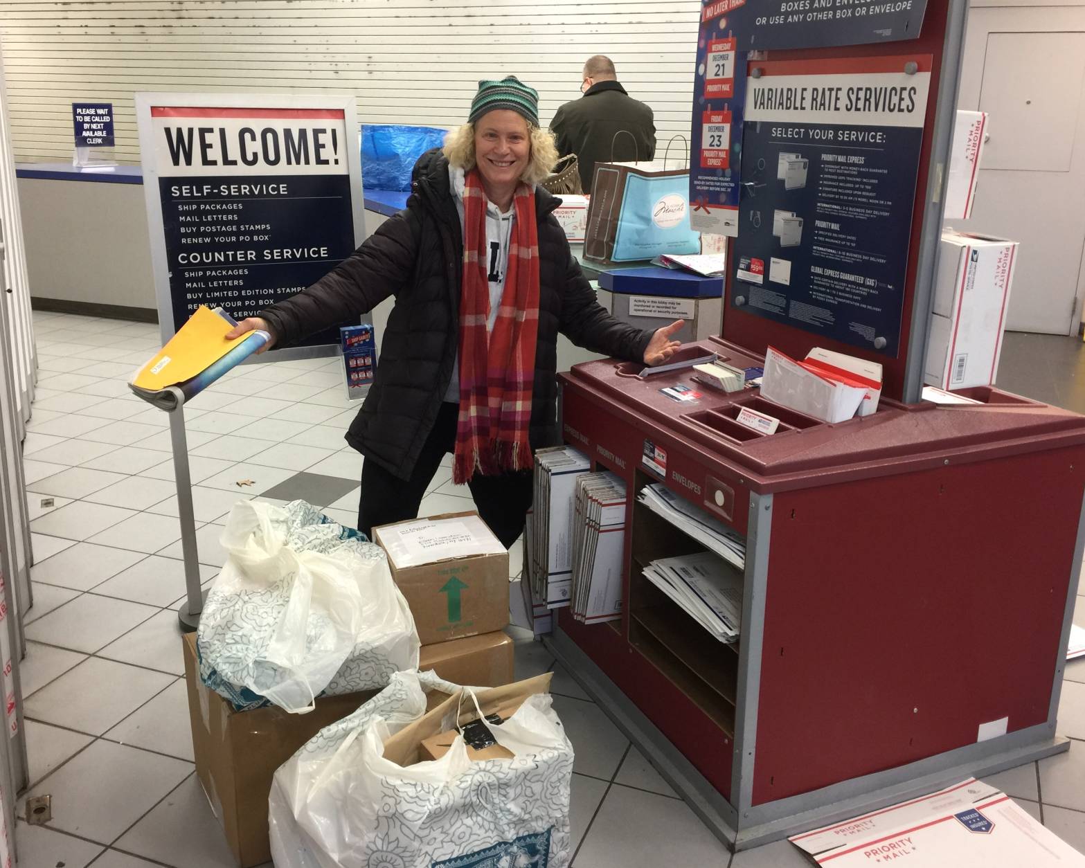“I have a gazillion packages to mail,” said Nancy Golding, of Northwest D.C., on Monday. Golding was the first in line awaiting the USPS Friendship Station opening on what the Postal Service expects will be the busiest day for mailing holiday cards, letters and packages. (WTOP/Kristi King)