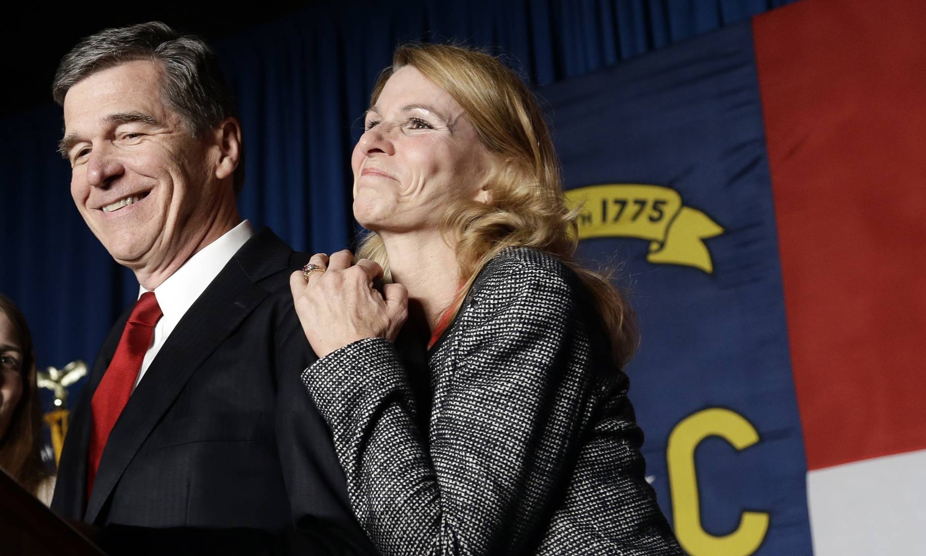 North Carolina Democratic candidate for governor Roy Cooper and his wife Kristin greet supporters during an election night rally in Raleigh, N.C., Wednesday, Nov. 9, 2016. The race between Cooper and Republican Gov. Pat McCrory remains too close to call. (AP Photo/Gerry Broome)