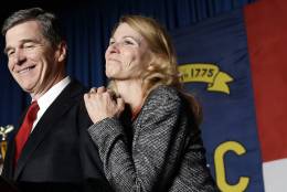 North Carolina Democratic candidate for governor Roy Cooper and his wife Kristin greet supporters during an election night rally in Raleigh, N.C., Wednesday, Nov. 9, 2016. The race between Cooper and Republican Gov. Pat McCrory remains too close to call. (AP Photo/Gerry Broome)