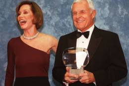 FILE - In this Saturday, Nov. 1, 1997, file photo, Television executive Grant Tinker holds up his Hall of Fame award alongside his ex-wife Mary Tyler Moore at the Academy of Television Arts &amp; Sciences' 13th Annual Hall of Fame induction ceremonies in the North Hollywood section of Los Angeles. Tinker, who brought "The Mary Tyler Moore Show" and other hits to the screen as a producer and a network boss, has died. Tinker died Monday, Nov. 28, 2016, at his home in Los Angeles, according to his son, Mark Tinker. (AP Photo/Chris Pizzello, File)