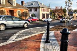 The $4.2 million project uses subtle design features to minimize speeds through the pedestrian zone, including crosswalks made of bricks, rather than the asphalt used on Washington Street. (WTOP/Neal Augenstein)