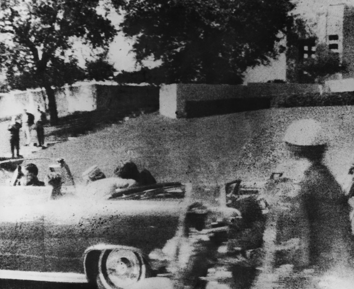 John F. Kennedy (1917 - 1963) is struck by an assassin's bullet as he travels through Dallas in a motorcade, 22nd November 1963. In the car next to him is his wife Jacqueline (1929 - 1994) and in the front seat is Texas governor John Connally. (Photo by Three Lions/Hulton Archive/Getty Images)