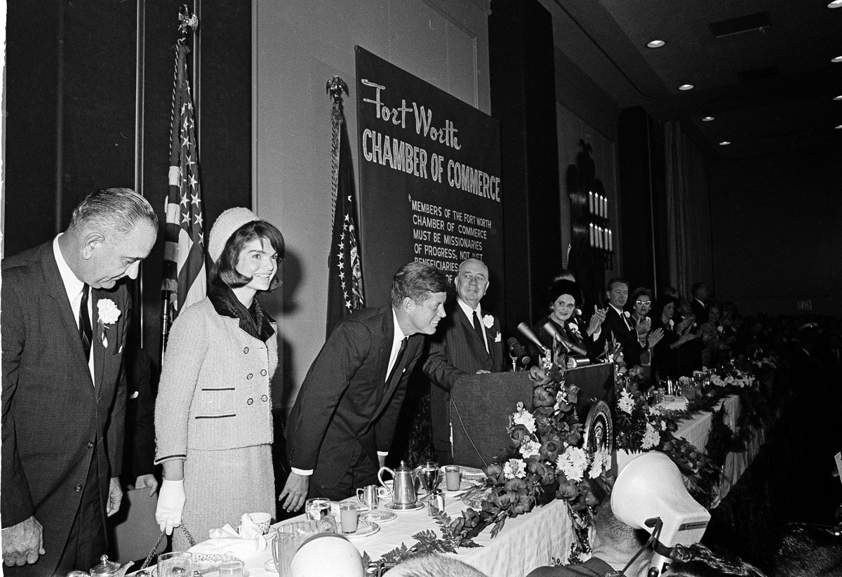 Hours before the assassination: First lady Jacqueline Kennedy arrives for the Fort Worth Chamber of Commerce breakfast at Fort Worth, Tex., Nov. 22, 1963. Greeting her are, from left, Lady Bird Johnson, Vice President Lyndon B. Johnson and President John F. Kennedy. Others are unidentified. (AP Photo/Ferd Kaufman)