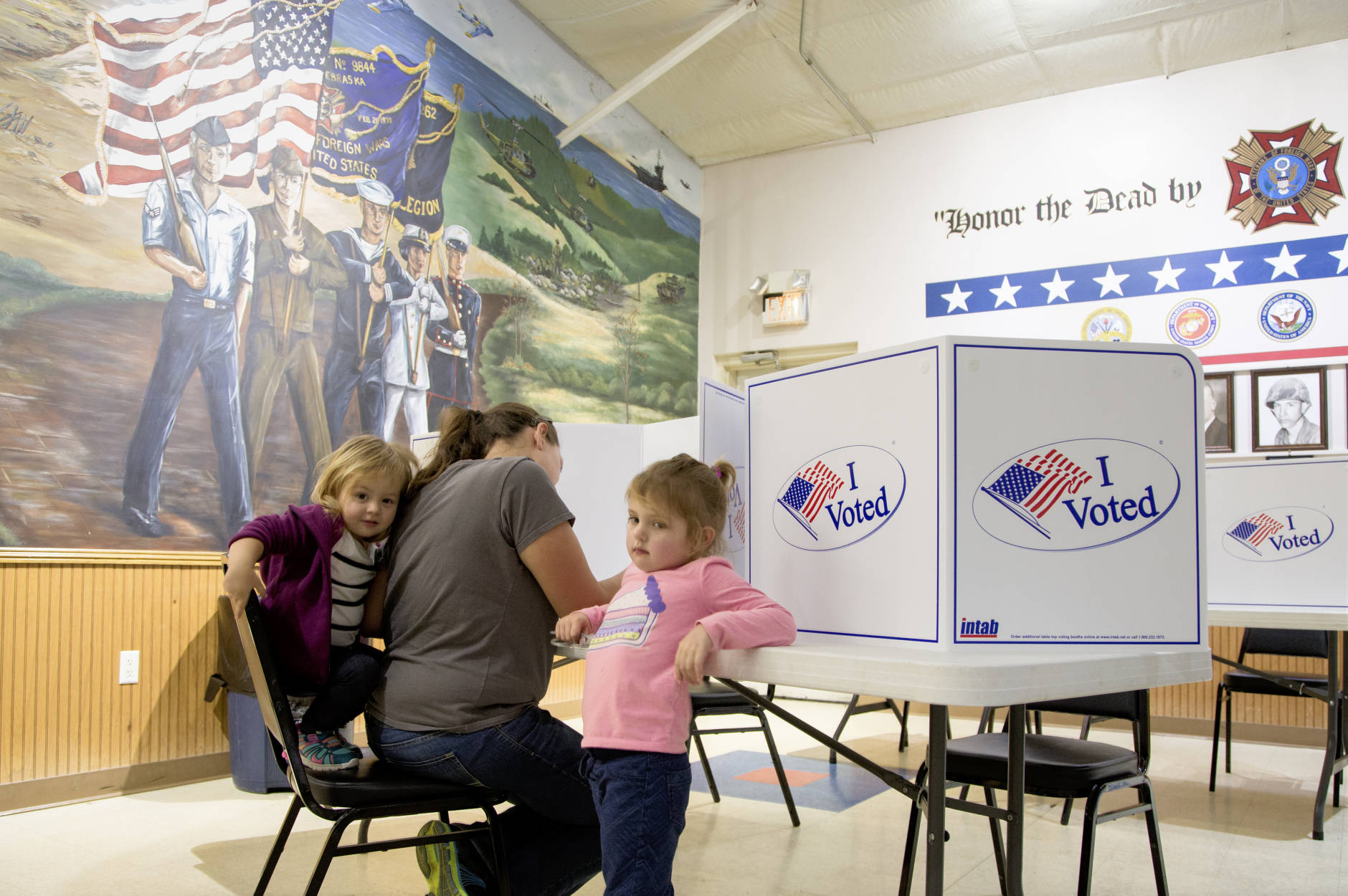 Michaela Case is accompanied by her daughters Emma, 4, right, and Jessie, 2, as she fills out her ballot at a polling station on election day in Yutan, Neb., Tuesday, Nov. 8, 2016. (AP Photo/Nati Harnik)