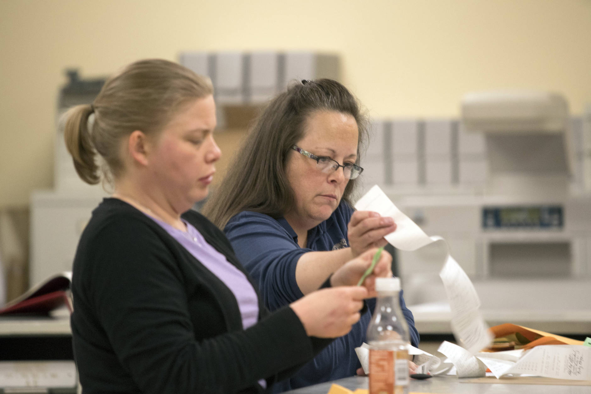 Rowan County Clerk Kim Davis, right, and County Democratic election representative Kathryn Reeder, count votes at the county courthouse Tuesday, November 8, 2016 in Morehead, Ky. Davis is the Kentucky clerk who was jailed for refusing to issue marriage licenses to gay couples.  (AP Photo/John Flavell)