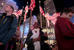 Marcella Merzius, center, watches a large screen showing Election Day coverage at Rockefeller Center, Tuesday, Nov. 8, 2016, in New York. (AP Photo/Julio Cortez)