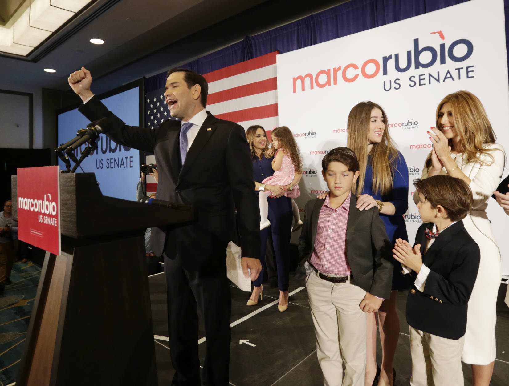 Florida Republican Sen. Marco Rubio acknowledges the cheers from supporters after winning a second term in office. Rubio defeated U.S. Rep. Patrick Murphy, a two-term congressman. His wife and children are behind him. (AP Photo/Wilfredo Lee)