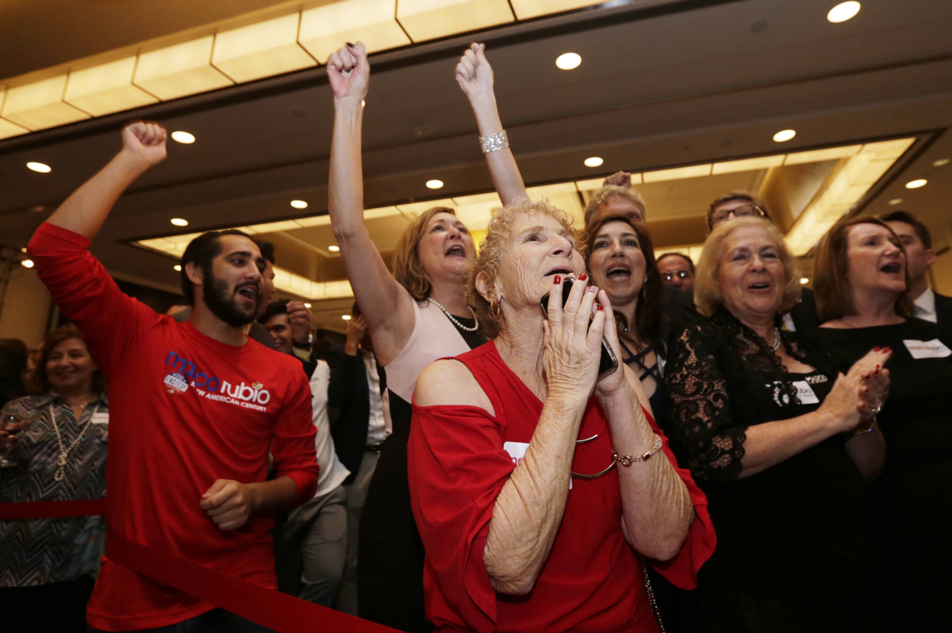 Supporters cheer as news outlets show Sen. Marco Rubio won a second term in Miami, Tuesday Nov. 8, 2016. Rubio defeated U.S. Rep. Patrick Murphy, a two-term congressman. (AP Photo/Wilfredo Lee)