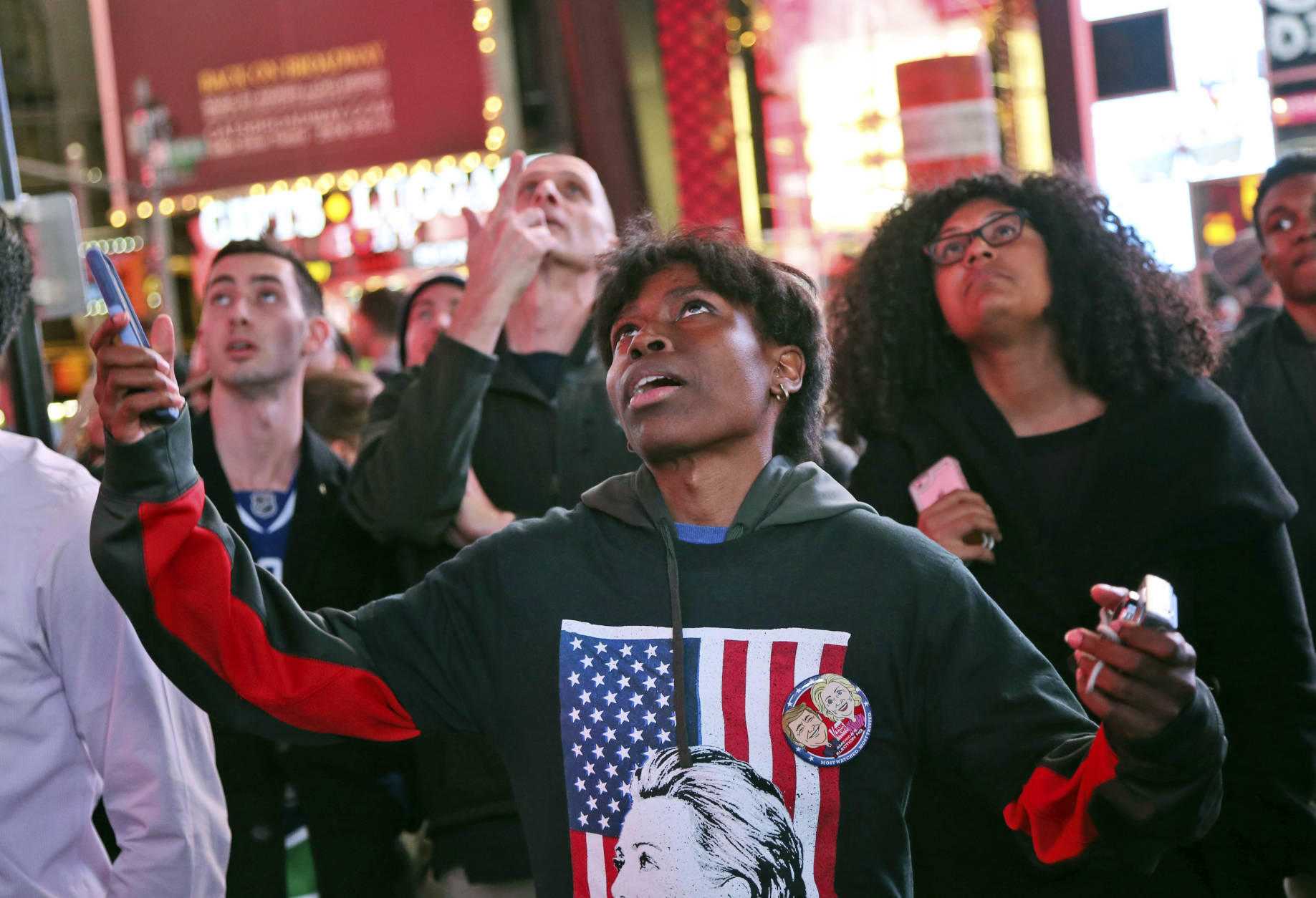 Kara Williams reacts to the news that Republican presidential candidate Donald Trump was ahead of Democratic presidential candidate, Hillary Clinton, in Florida while watching election results in Times Square, New York, Tuesday, Nov. 8, 2016. (AP Photo/Seth Wenig)