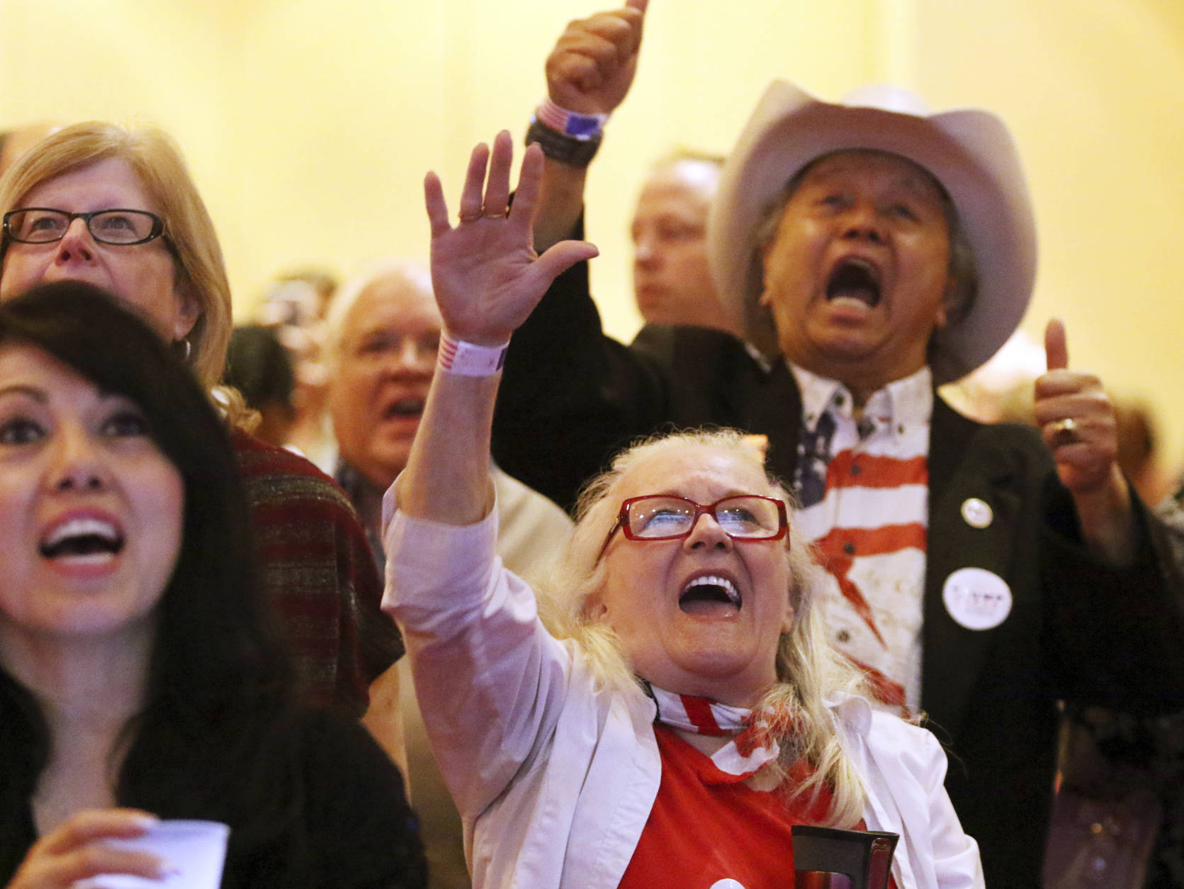 Stephanie Reeder, right, and Eddie Hamilton, back right, cheer during an election night watch party hosted by the Nevada GOP, Tuesday, Nov. 8, 2016, at South Point hotel-casino in Las Vegas. (AP Photo/Ronda Churchill)