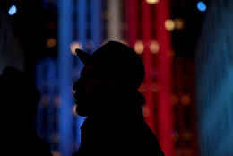 A person is silhouetted against the 30 Rockefeller building illuminated in patriotic lights during an Election Night gathering at Rockefeller Center, Tuesday, Nov. 8, 2016, in New York. (AP Photo/Julio Cortez)