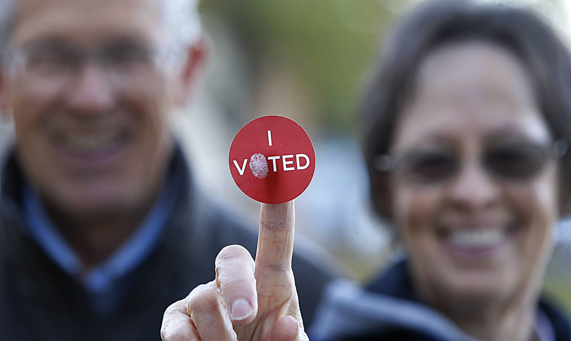 PROVO, UT - NOVEMBER 08: A couple shows off their "I Voted" sticker as they leave Wasatch Elementary school after casting their ballot in the presidential election on November 8, 2016 in Provo, Utah.   Americans across the nation make their choice for the next president of the United States today.  (Photo by George Frey/Getty Images)