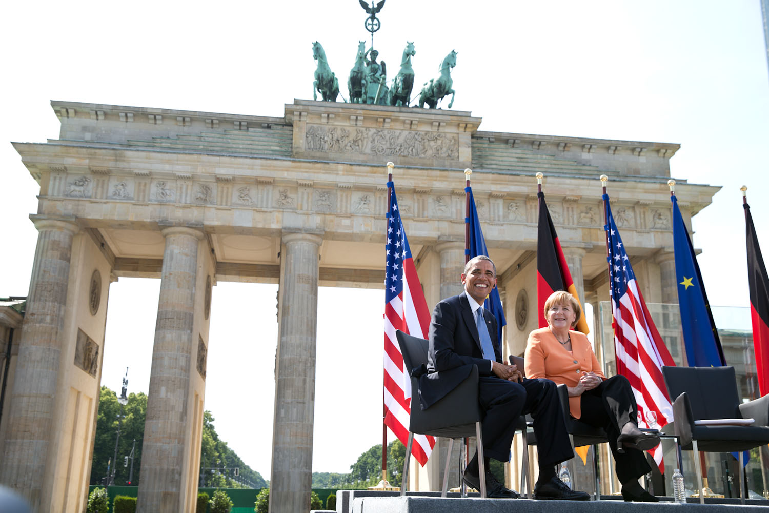 June 19, 2013
"The President and German Chancellor Angela Merkel listen to remarks by Berlin Mayor Klaus Wowereit at the Brandenburg Gate in Berlin. The last time I had been here was in 1987 on the opposite site of the Gate when President Reagan had challenged Russian President Mikhail Gorbachev to 'tear down this wall.'"
(Official White House Photo by Pete Souza)

This official White House photograph is being made available only for publication by news organizations and/or for personal use printing by the subject(s) of the photograph. The photograph may not be manipulated in any way and may not be used in commercial or political materials, advertisements, emails, products, promotions that in any way suggests approval or endorsement of the President, the First Family, or the White House.