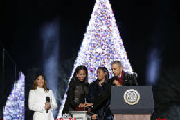 President Barack Obama, first lady Michelle Obama and their daughter Sasha light the 2016 National Christmas Tree during the National Christmas Tree lighting ceremony at the Ellipse near the White House in Washington, Thursday, Dec. 1, 2016. Also on stage is the host Eva Longoria. (AP Photo/Pablo Martinez Monsivais)