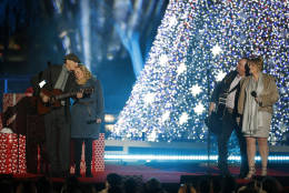 James Taylor, left, with his wife Caroline "Kim" Smedvig, Garth Brooks, and Tricia Yearwood perform during the lighting ceremony for the 2016 National Christmas Tree on the Ellipse near the White House, Thursday, Dec. 1, 2016 in Washington. (AP Photo/Alex Brandon)