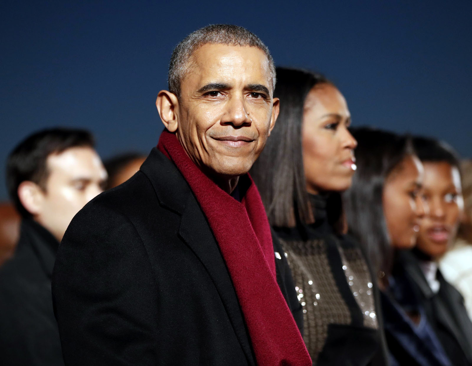 President Barack Obama, sits with first lady Michelle Obama, center, and their daughter Sasha, right, to watch the musical performances at the lighting the 2016 National Christmas Tree ceremony at the Ellipse near the White House in Washington, Thursday, Dec. 1, 2016. (AP Photo/Pablo Martinez Monsivais)