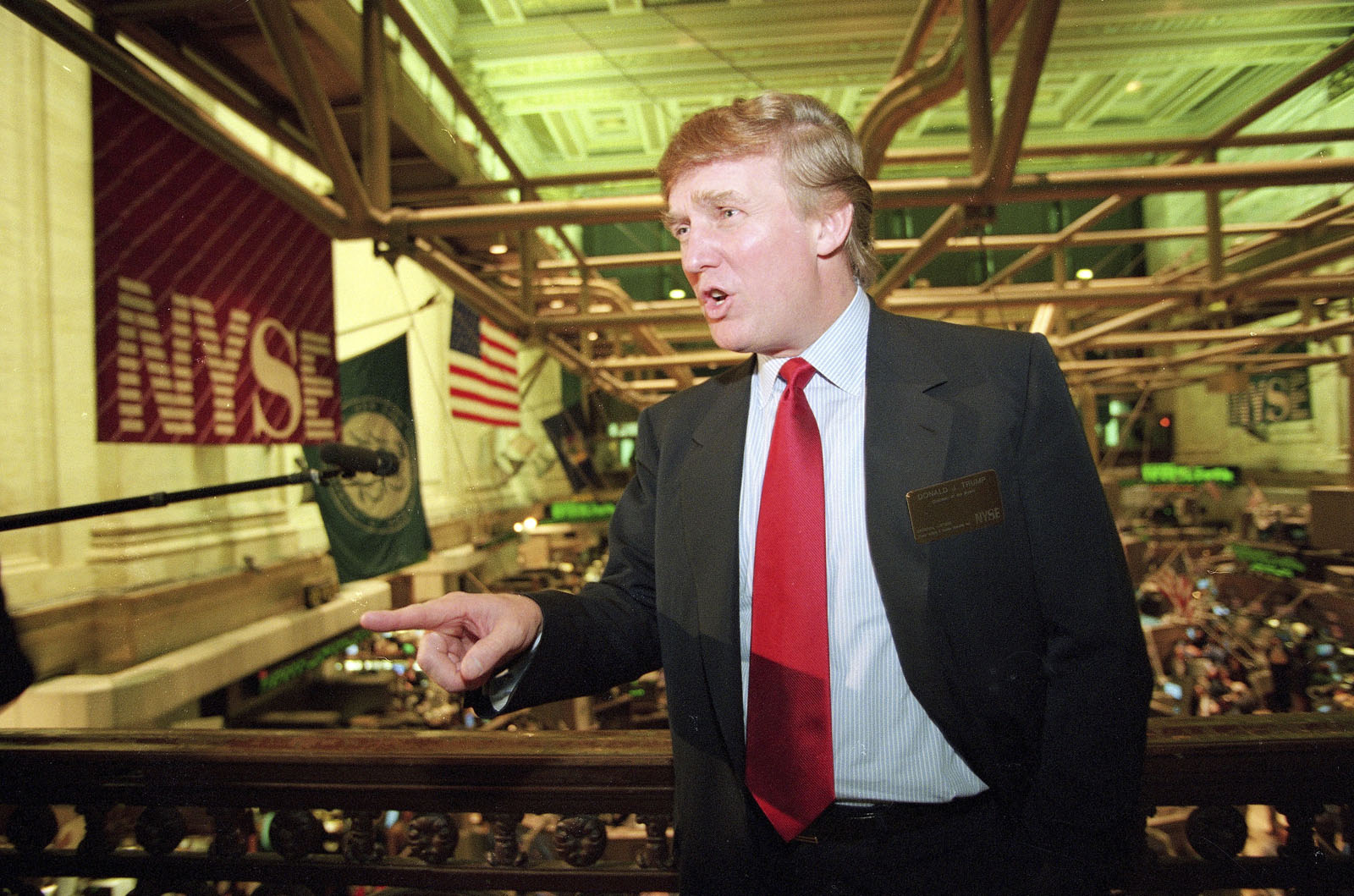 File-This June 7, 1995, file photo shows real estate magnate Donald Trump posing for photos above the floor of the New York Stock Exchange after taking his flagship Trump Plaza Casino public in New York City. Trump's business losses in 1995 were so large that they could have allowed him to avoid paying federal income taxes for as many as 18 years, according to records obtained by The New York Times.  (AP Photo/Kathy Willens, File)