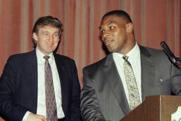 Heavyweight champion Mike Tyson, right, speak at a news conference while advisor Donald Trump looks in New York, Tuesday, July 27, 1988 after announcing a settlement between Tyson and his manager, Bill Cayton. Tyson, who had sued to break his contract with Cayton, reached an ou-of-court settlement under which Cayton will remain his manager until Feb. 11, 1992. (AP Photo/Richard Drew)