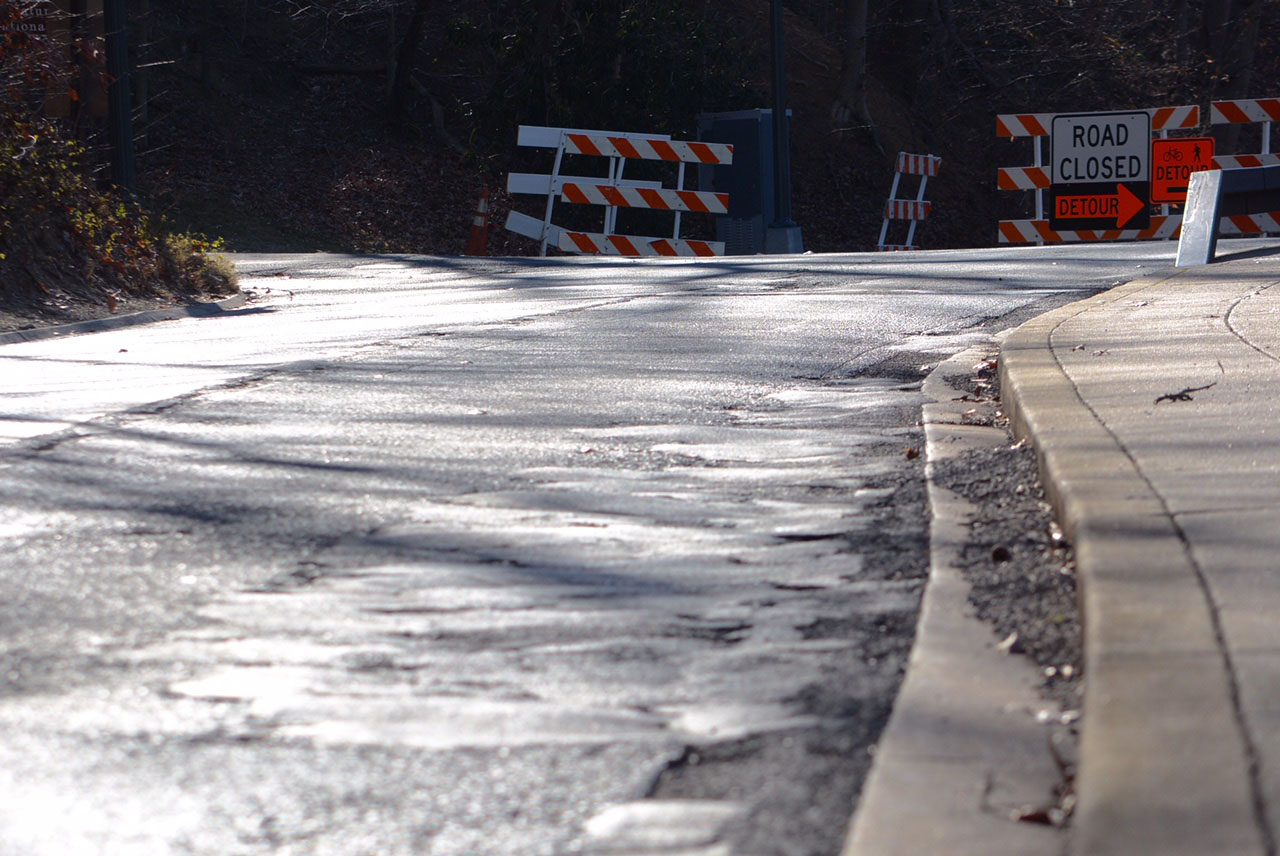 A section of Beach Drive near Peirce Mill has been patched over and over again. The road has outlasted its service life and will be rebuilt over the next three years. (WTOP/Dave Dildine)