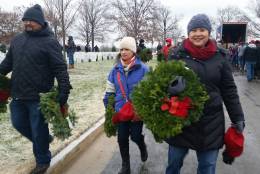 The opening ceremony of the Wreaths Across America ceremony had to be canceled Saturday morning due to freezing rain, but 44,000 volunteers still showed up to participate Saturday morning, Dec. 16, 2016 at Arlington National Cemetery. (WTOP/Kathy Stewart)