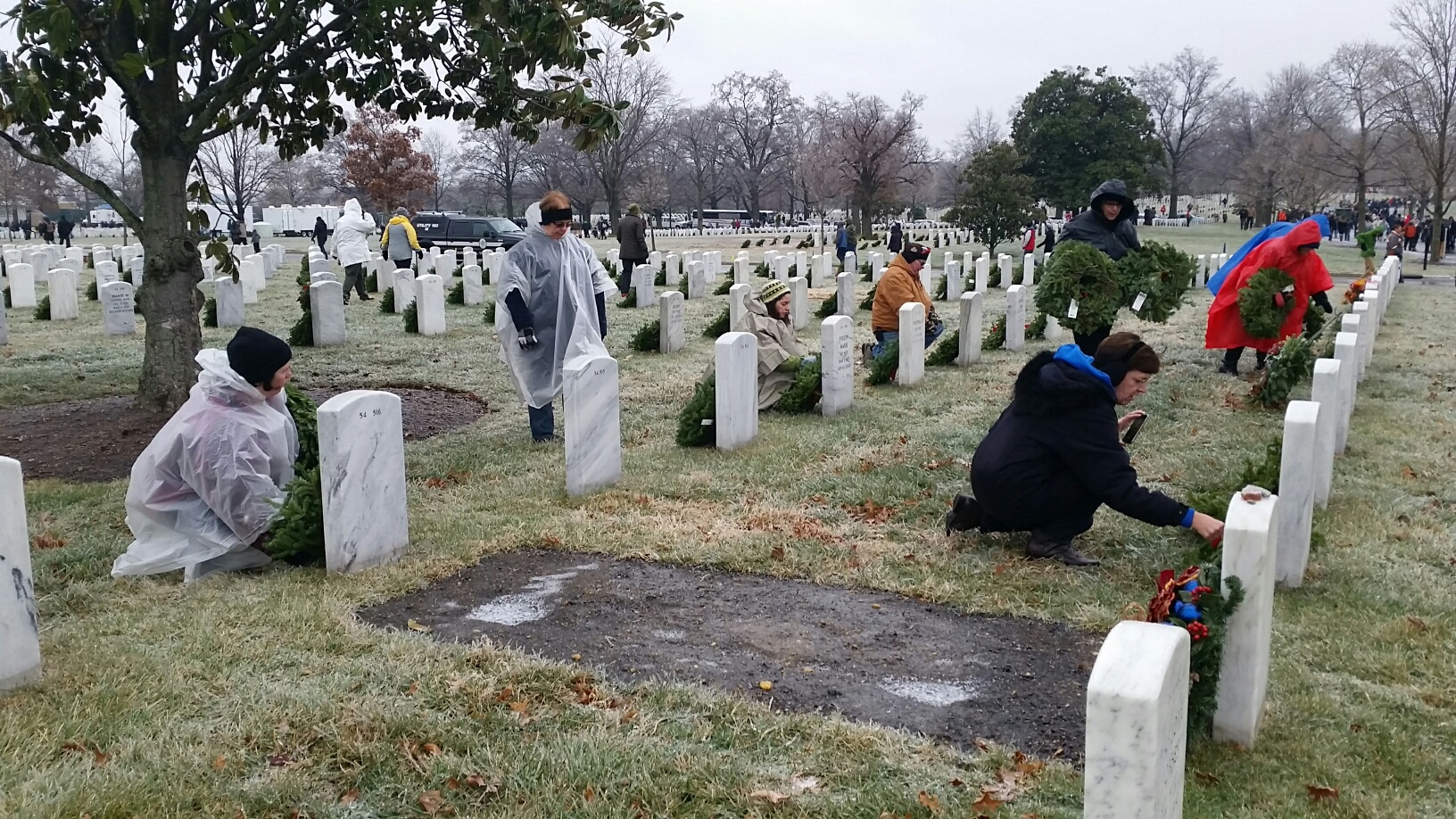 Despite icy road conditions and a winter weather advisory, 44,000 volunteers showed up at Arlington Cemetery to lay wreaths to honor veterans Saturday morning, Dec. 17, 2016. (WTOP Kathy Stewart)