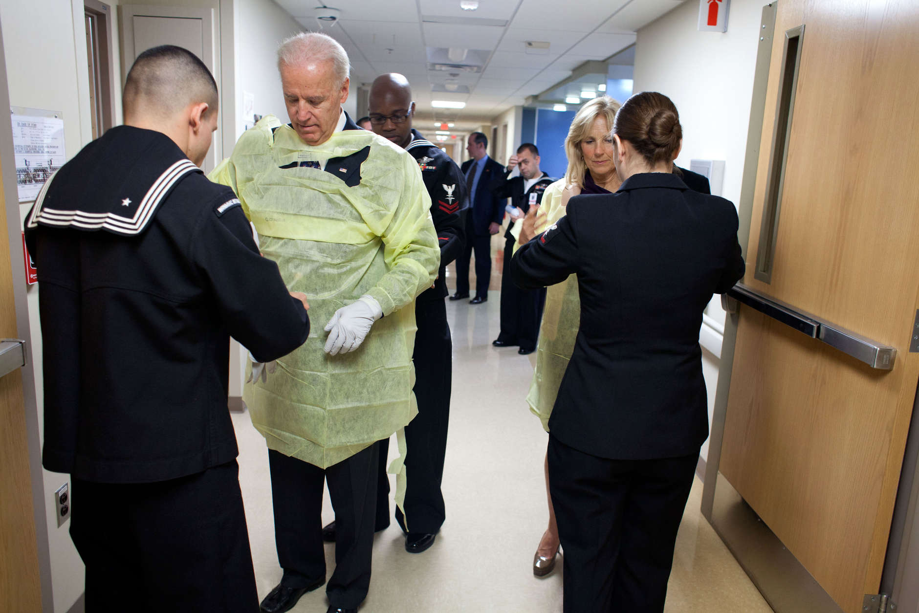 Navy corpsmen help Vice President Joe Biden and Dr. Jill Biden into gowns before meeting with patients and their families during a Christmas visit to Walter Reed National Military Medical Center in Bethesda, Md., Dec. 25, 2011. (Official White House Photo by David Lienemann)  

This official White House photograph is being made available only for publication by news organizations and/or for personal use printing by the subject(s) of the photograph. The photograph may not be manipulated in any way and may not be used in commercial or political materials, advertisements, emails, products, promotions that in any way suggests approval or endorsement of the President, the First Family, or the White House.