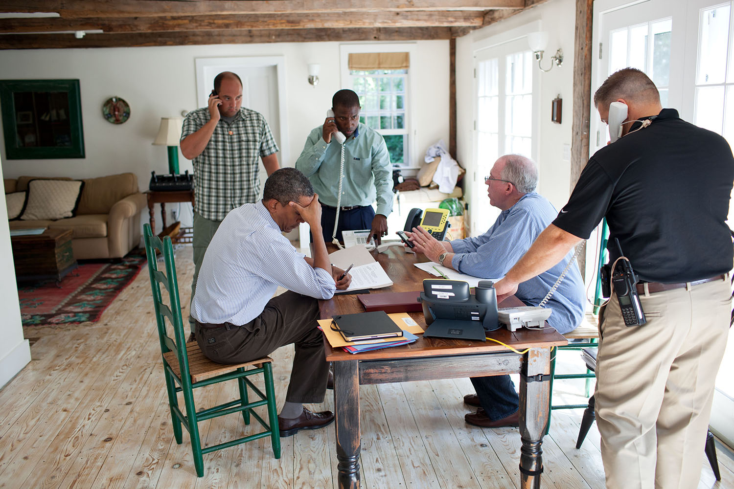 Aug. 26, 2011
"A former President once said, 'Presidents don't get vacations, they just get a change of scenery.'  We were on 'vacation' in Martha's Vineyard and the President was monitoring Hurricane Irene with John Brennan, Assistant to the President for Homeland Security and Counterterrorism, at right in light blue shirt. They were waiting for a conference call on the hurricane with affected governors and mayors."
(Official White House Photo by Pete Souza)

This official White House photograph is being made available only for publication by news organizations and/or for personal use printing by the subject(s) of the photograph. The photograph may not be manipulated in any way and may not be used in commercial or political materials, advertisements, emails, products, promotions that in any way suggests approval or endorsement of the President, the First Family, or the White House.
